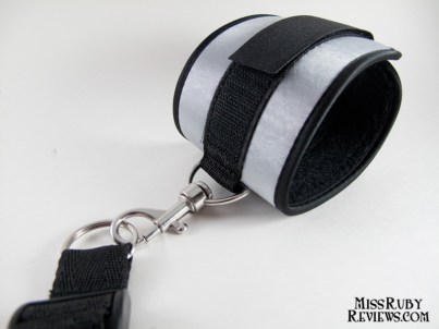 Cuffs hook onto rings on the restraint harness